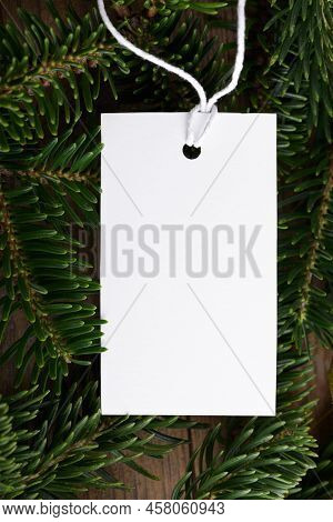 Christmas Rectangle White Tag Mockup With White Cord, Close Up On Natural Fir Tree Branch, With Cone