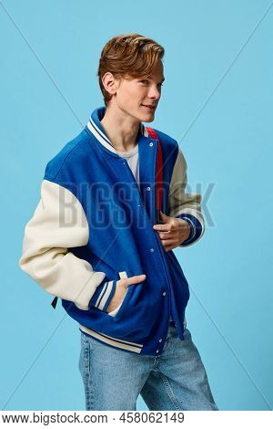 A Handsome Happy Guy Student In A Fashionable Bomber Jacket And With A Backpack On His Shoulder Stan