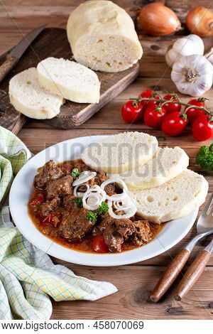 Czech Traditional Recipe For Beef Goulash With Homemade Dumpligs, Served In Simple Rustic Style