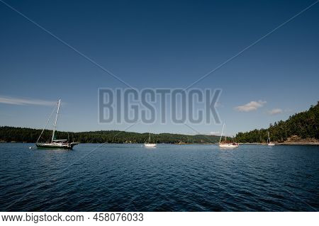Boats At Anchor On A Sunny Day Near Pender Harbour, British Columbia, Canada