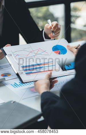 Two Businessmen Are Reviewing Monthly Sales Documents For Analysis And Marketing Plans For More Sale