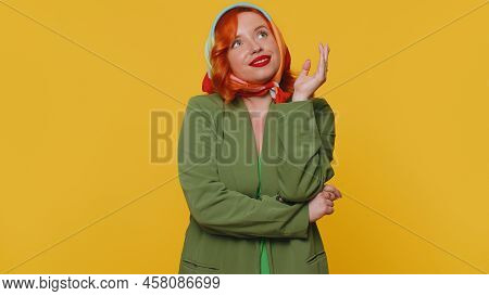 Redhead Young Woman In Thought And Conjectures Looking To Side, Dreaming, Imagining Something Pleasa