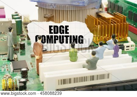 Technology And Computer Concept. On The Motherboard There Are Figures Of People And Torn Paper With 