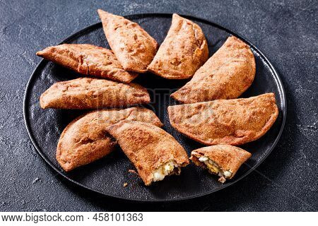 Fried Empanadas, Hand Pies With Hard Boiled Egg Fillings On Black Platter On Concrete Table, Horizon