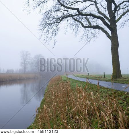 Valleikanaal Or Valley Canal Near Scherpenzeel In Dutch Province Of Utrecht On Misty Winter Day