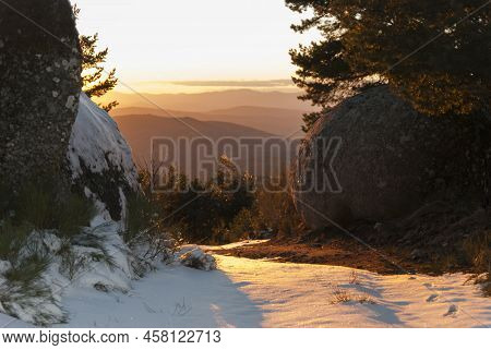 Snowy Road At Sunset In La Muela, La Garganta Extremadura, Snowy Rocks And Pine Trees In Spring