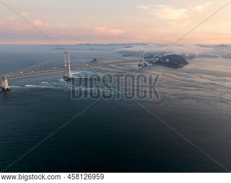 Strong Tidal Current Flows Under Naruto Suspension Bridge At Sunset