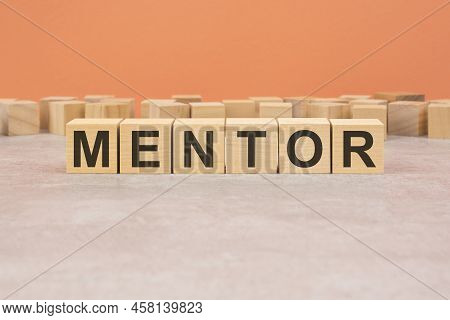 Word Cubes Lined Up With The Letters Mentor Written On It. Copy Space Available