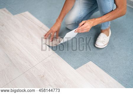 Installing New Vinyl Laminate. Woman Fixing Floor. Diy Project
