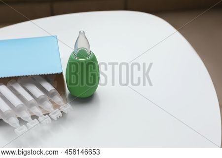 Package With Single Dose Ampoules Of Sterile Isotonic Sea Water Solution And Nasal Aspirator On Whit