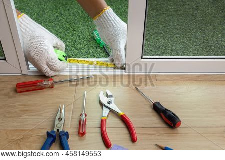 Worker Fixing The Insect Screen Sliding Door