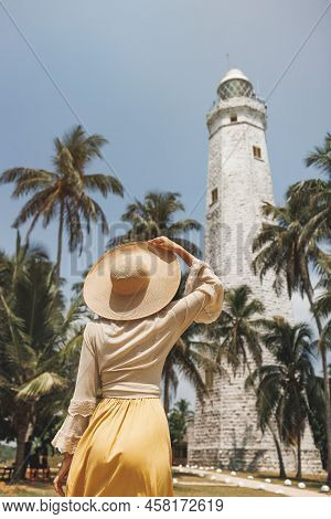 Woman Traveler Visiting Famous Landmarks Of Sri Lanka Country Standing And Looking On Dondra Lightho