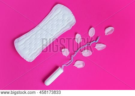 Female Tampon With With Cherry Petals And Woman Gasket On A Pink Background. Hygienic White Tampon F
