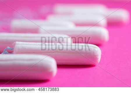 Medical Female Tampon Close Up On A Pink Background. Hygienic White Tampon For Women. Cotton Swab. M