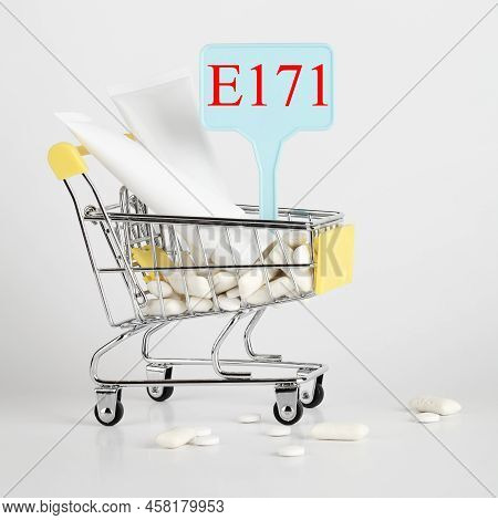 Titanium Dioxide, E171, Dangerous Additive Concept. Gum, Pills, Toothpaste, Cream In Basket And Sign