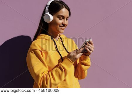 Young Smiling Woman With Headphones Chating Phone
