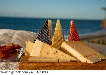 Assortment Of Spanish Hard Cheeses, Curado, Manchego, Goat Cheese Served Outdoor With Membrillo Jam