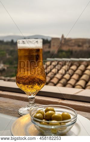 Spanish Beer And Glass Bowl With Green Andalusian Olives Served On Outdoor Terrace With View On Sier