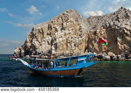Oman - July 15, 2022: Sailing Tourist Dhow Boat In Oman Mountain Fjords, Khasab.