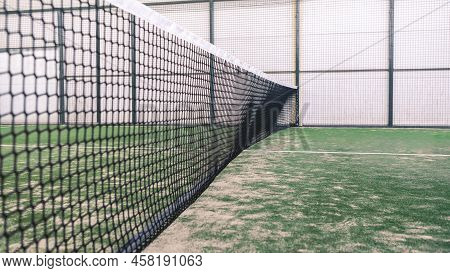 Net And Part Of Green Synthetic Grass Paddle Tennis Court Indoor Without People