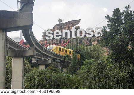Singapore- Apr 2, 2022: Sentosa Island Sign With The Monorial Pass Through It.