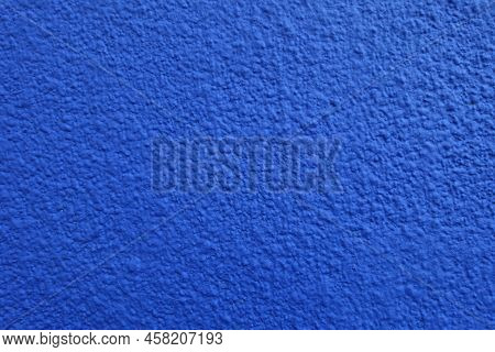 Closeup Of Wall With Coarse Vibrant Blue Roughcast Finish