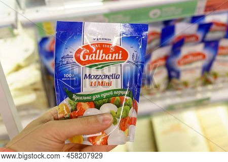 Tyumen, Russia-may 26, 2022: Man Hand Holding Pack With Delicious Galbani Mini Mozzarella At The Sup