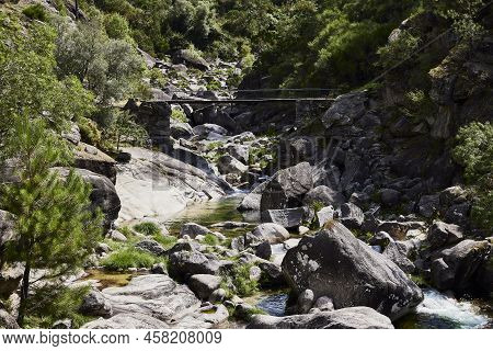 Waterfall And Rocks Of The Fafiao River, In The Gerês Natural Park (portugal)