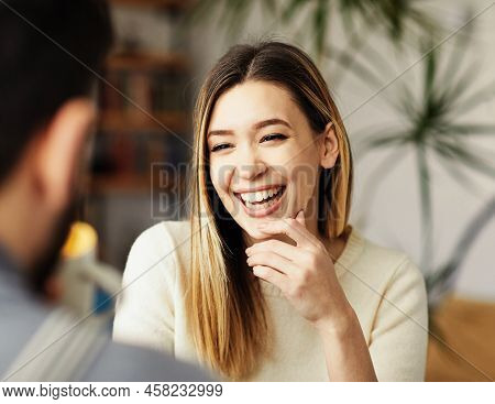 Portrait Of A Young Happy Girl Talking With A Friend