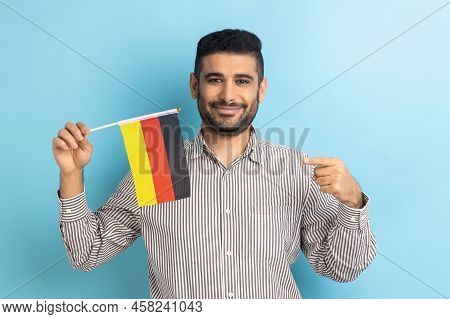 Portrait Of Pleased Man With Beard Pointing At Germany Flag, Celebrating Day Of Germany - 3th Octobe
