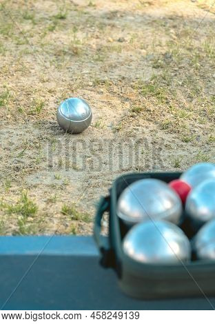 Invitation To Petanque Game Concept, No People. Metal Balls And Cochonnet Set Blurred In Foreground,