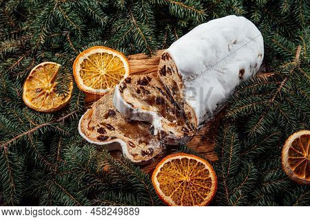 Christmas Stollen On Wooden Background. Traditional Christmas German Dessert Cut Into Pieces. Cake W