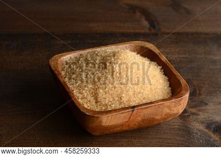 Raw Crystal Sugar In A Bowl On An Old Wood Table