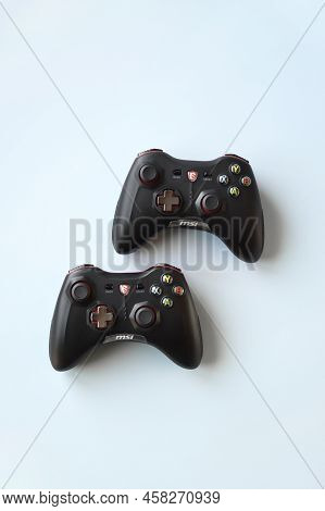 Two Msi Joystick Gaming Controller On Light Blue Background.