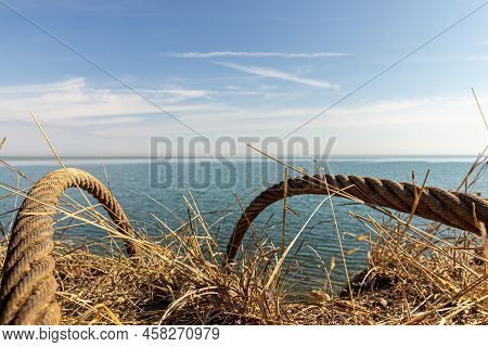 Old Rope For Ships Going Over Cliff Into Lake