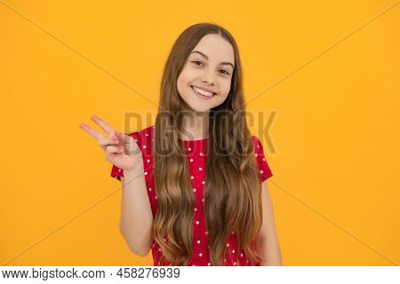 Cheaky Teen Girl Giving Victory Sign. Happy Teenager Child Smiling With V-sign, Positive Gesture, St