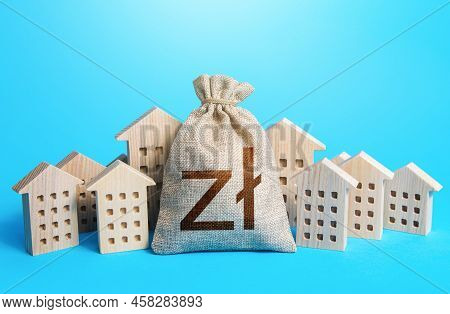Polish Zloty Money Bag Among Town Houses Figurines. Municipal Budgeting. Rental Business. Realtor Se