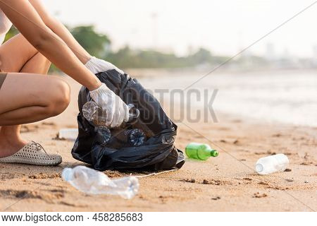 Volunteer Woman Picking Plastic Bottle Into Trash Plastic Bag Black For Cleaning The Beach, Female C