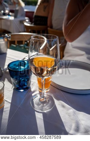 Dinner At Sunset In French Restaurant With Cold Dry Rose Wine In Port Grimaud, Summer Vacation On Fr