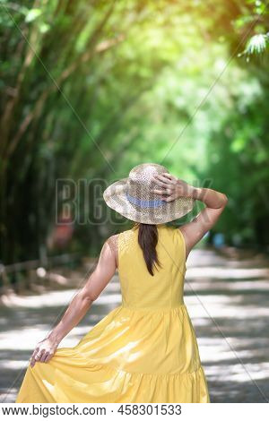 Asian Woman In Yellow Dress And Hat Traveling At Green Bamboo Tunnel, Happy Traveler Walking Chulabh