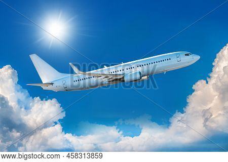 White Passenger Airliner Takes Off In The Blue Sky