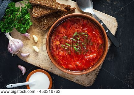 Traditional Ukrainian Borscht With Green Onion And Sour Cream. Delicious Beet Soup In Bowl With Rye 