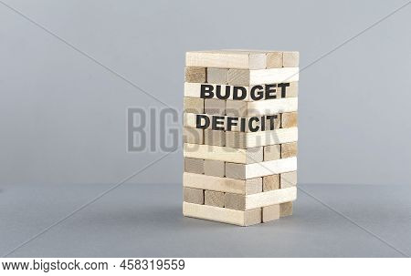 Budget Deficit Text On Wooden Block , Grey Background