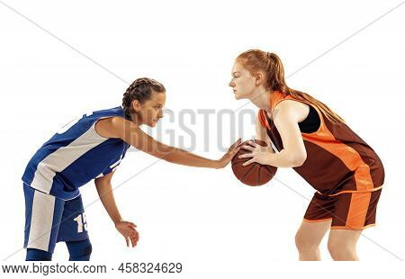 Studio Shot Of Beginner Basketball Players, Young Girls, Teen Training With Basketball Ball Isolated
