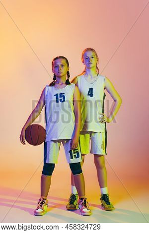 Two Sportive Girls, Teens, Basketball Players Standing Together With Basketball Ball Isolated On Pin