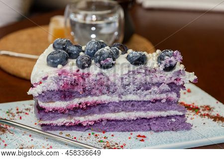 Sweet Cake Dessert With Blueberry On Thew Plate And Glass Of Water. Сonfectioner's Shop.