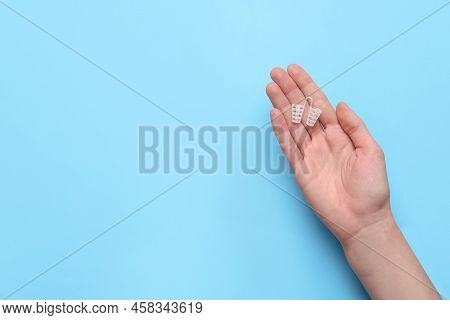 Woman Holding Anti-snoring Device On Light Blue Background, Top View. Space For Text