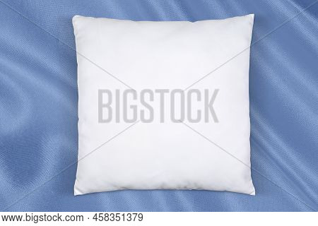 Square Throw Pillow Taking A Nap On Luxurious Baby Blue Fabric.