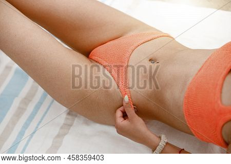 Close Up Of Sexy Woman On Beach Towl In Swimsuit With Ideal Fitness Body. Blurred Background