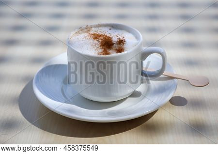 A Cup With Latte Macchiato, Cafe Latte Stands On A Table.